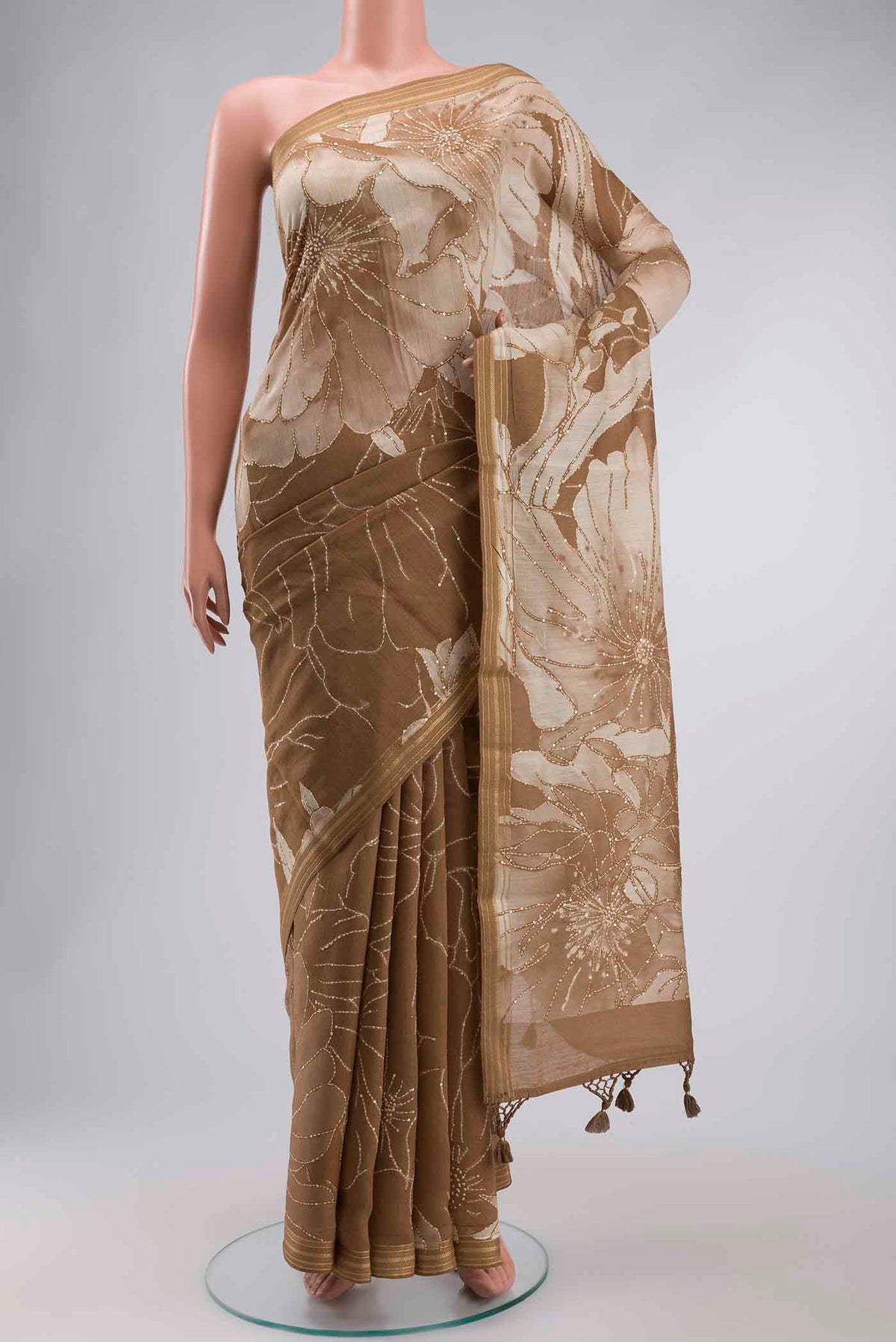 Green Tussar Silk Saree with Embroidery on the body and Zari Border displayed on a mannequin