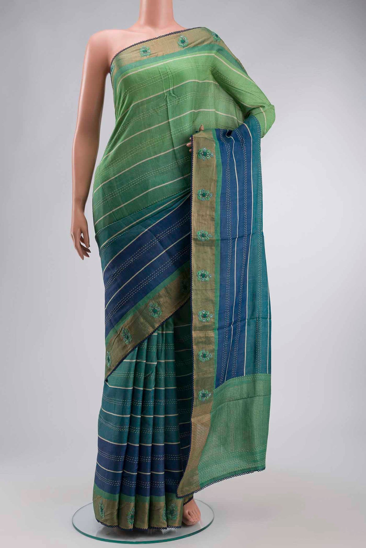 Green Tussar Silk Saree with Embroidery on the body and Zari Border displayed on a mannequin