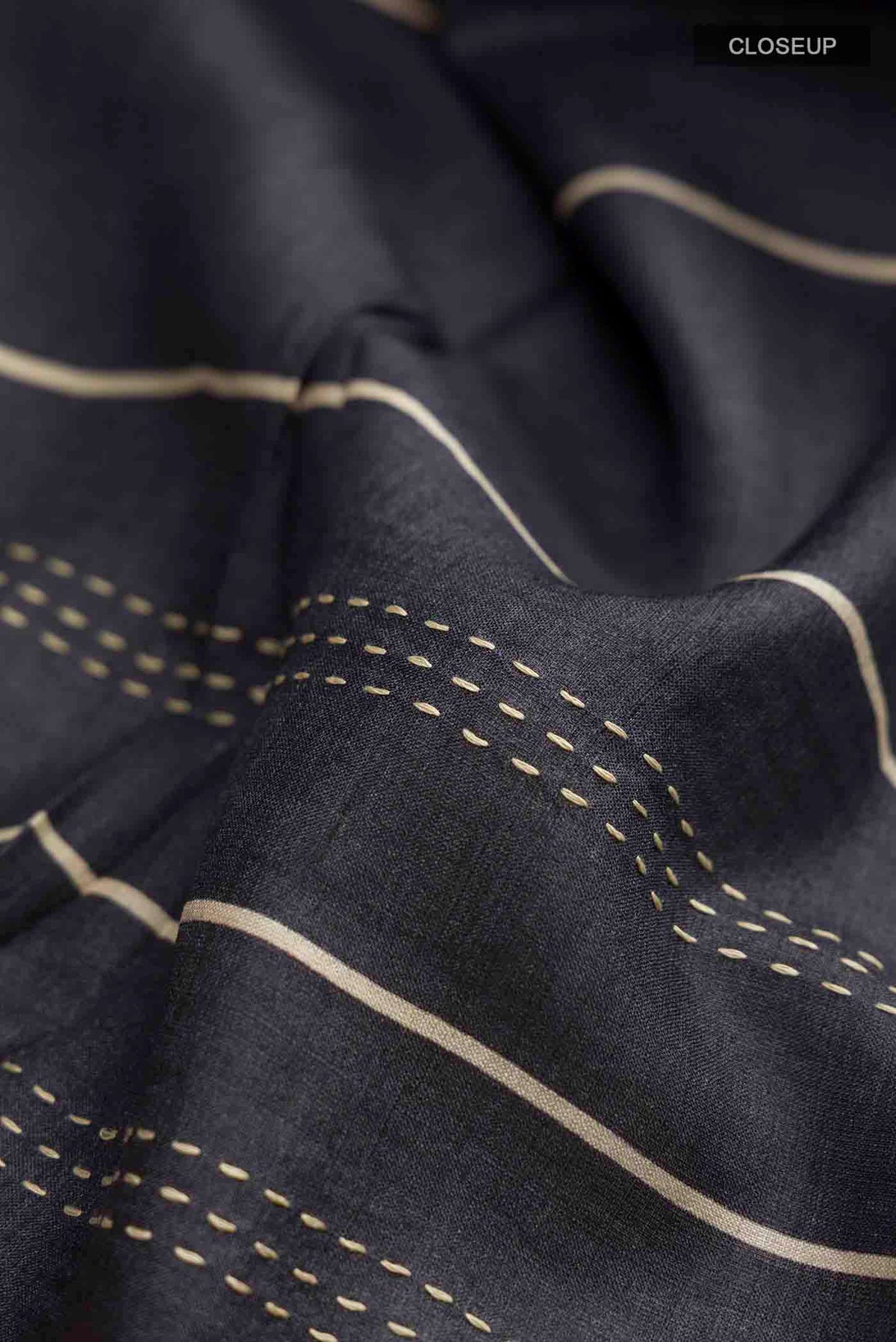 Close up of Multi Color Tussar Silk Saree with Embroidery on the body and Embroidery Border displaying folds