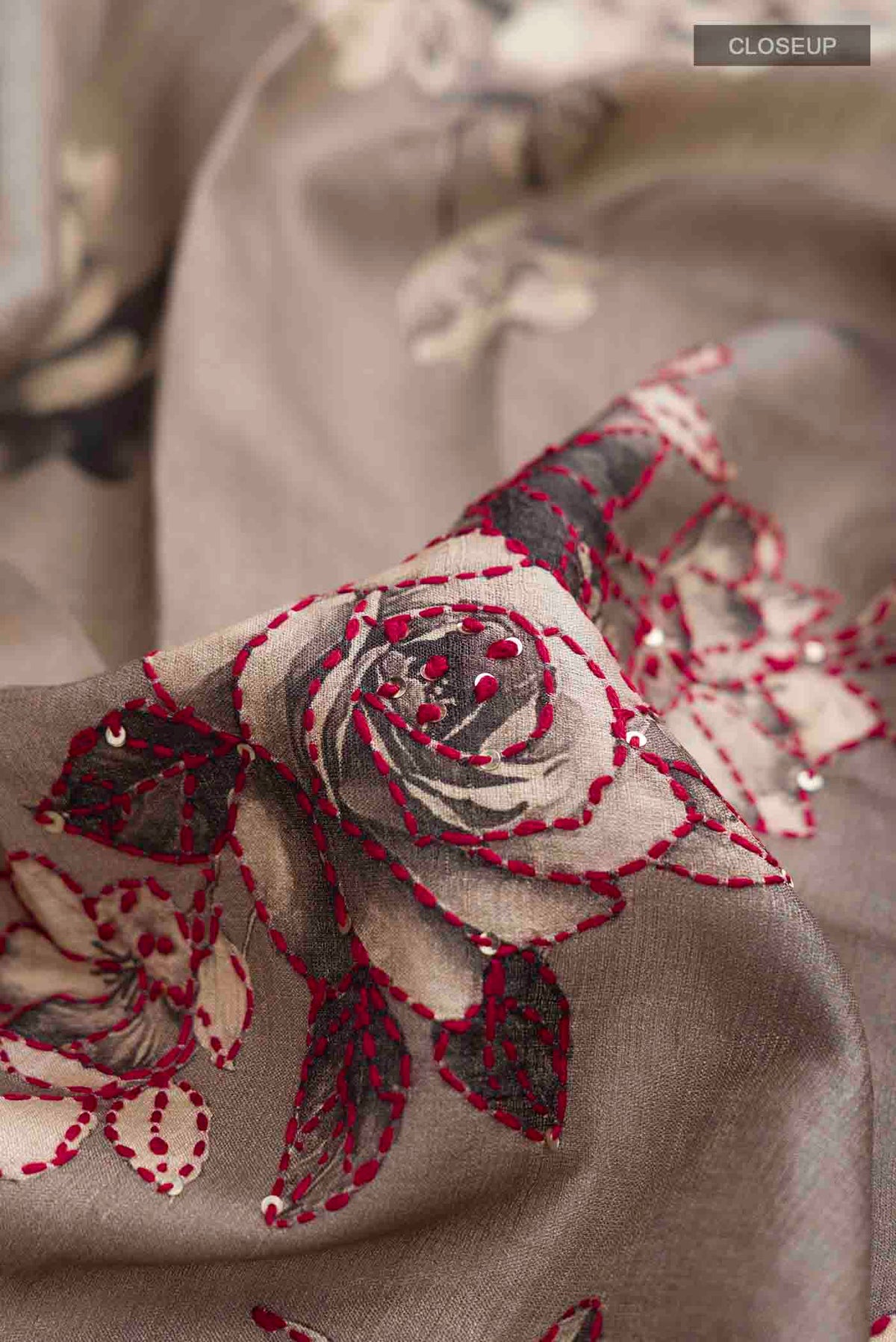 Close up of Blue Tussar Silk Saree with Embroidery on the body and Zari Border displaying folds