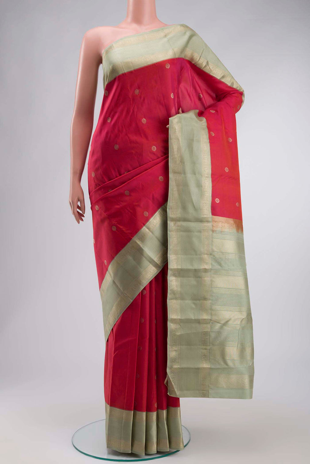 Coral Kanchipuram Silk Saree with Zari Butta on the body and Zari Border displayed on a mannequin