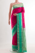 Pink Kanjivaram Silk Saree with Zari Butta on the body and Zari Border.  displayed on a mannequin