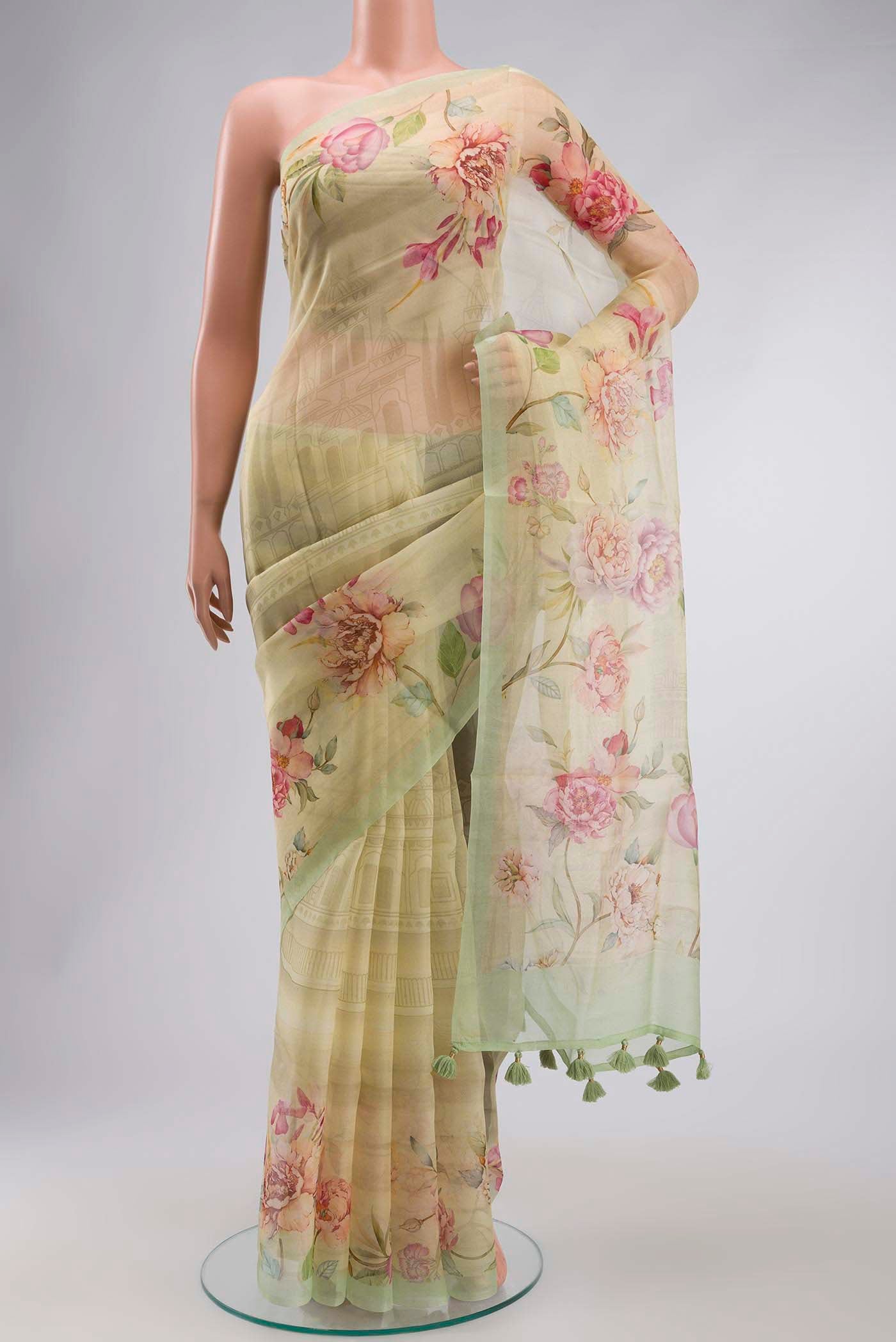 Yellow Organza Silk Saree with Printed design on the body and Plain Border displayed on a mannequin