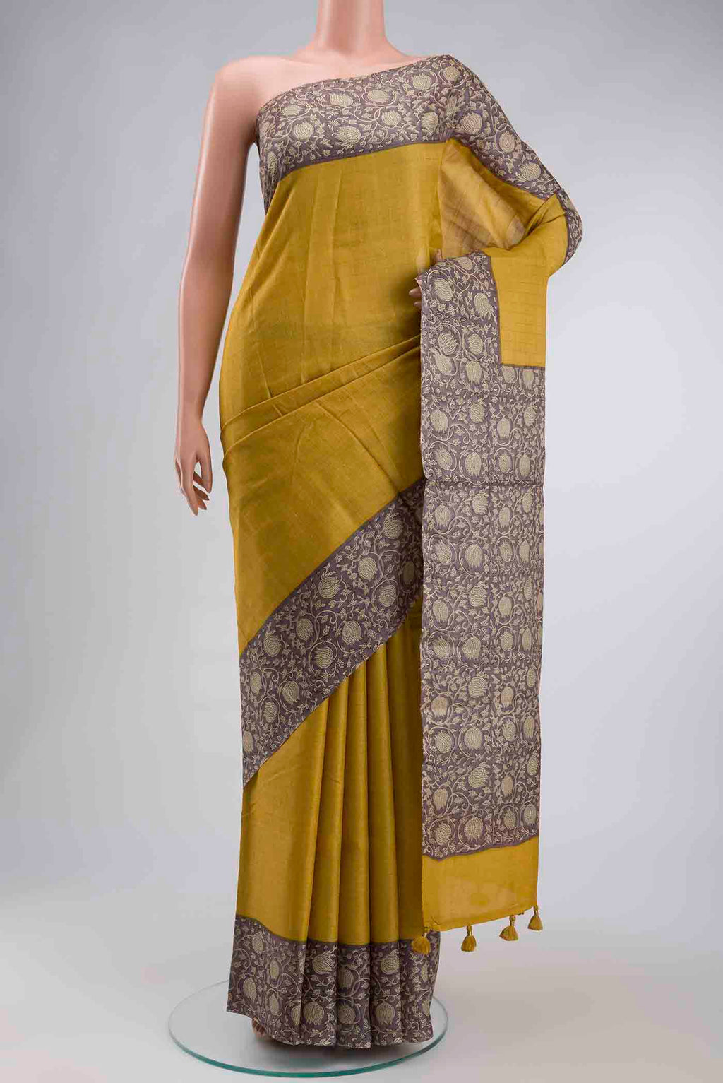 Yellow Tussar Silk Saree with Checked design on the body and Printed Border displayed on a mannequin