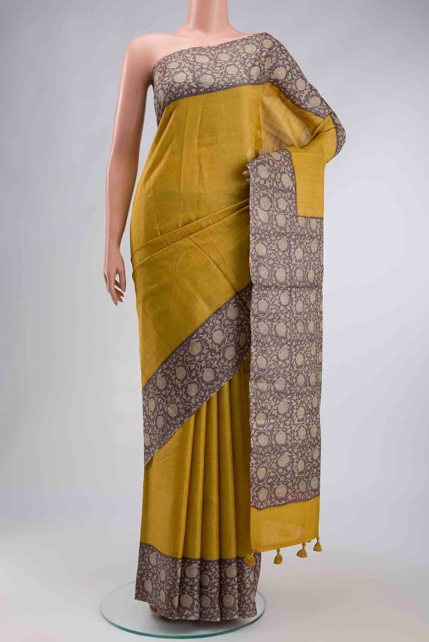 Yellow Tussar Silk Saree with Checked design on the body and Printed Border displayed on a mannequin