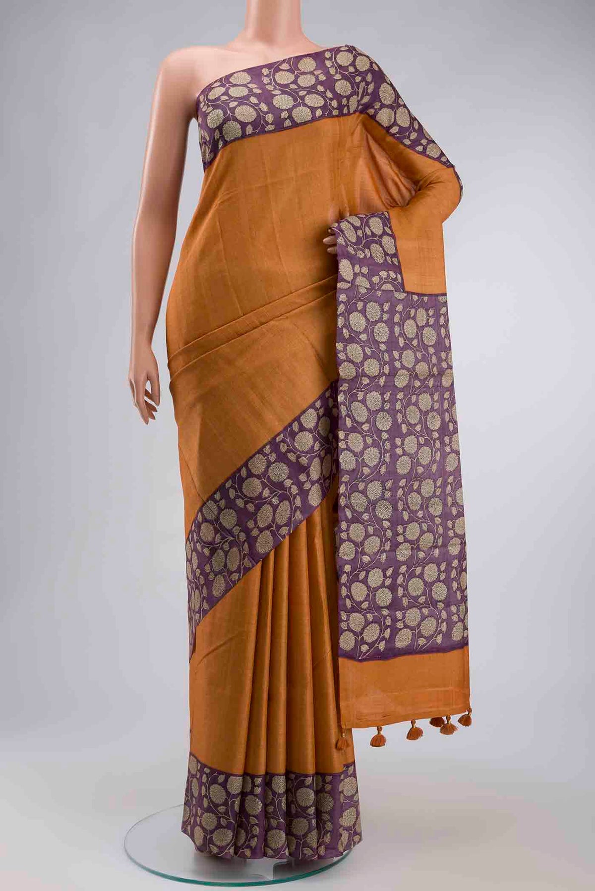 Orange Tussar Silk Saree with Checked design on the body and Printed Border displayed on a mannequin