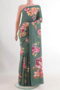 Blue Grey Crepe Saree with Printed design on the body and Printed Border.  displayed on a mannequin