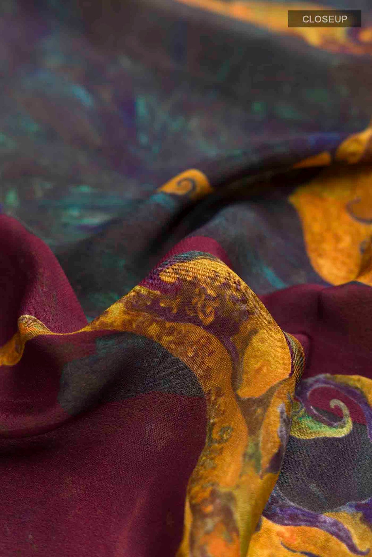 Close up of Multi Color Mysore Crepe Saree with Printed design on the body and Printed Border displaying folds