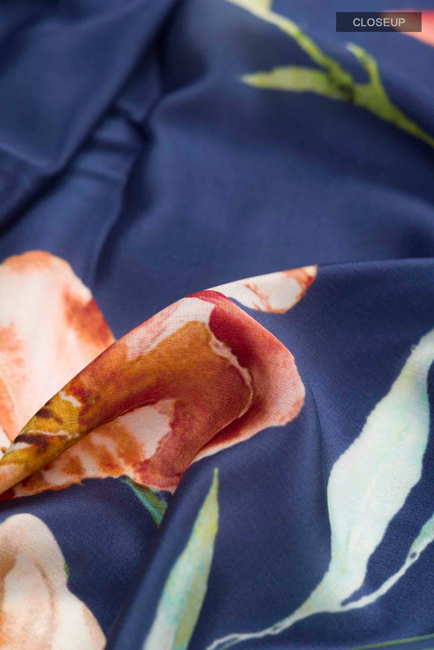 Close up of Blue Mysore Crepe Saree with Printed design on the body and Plain Border displaying folds