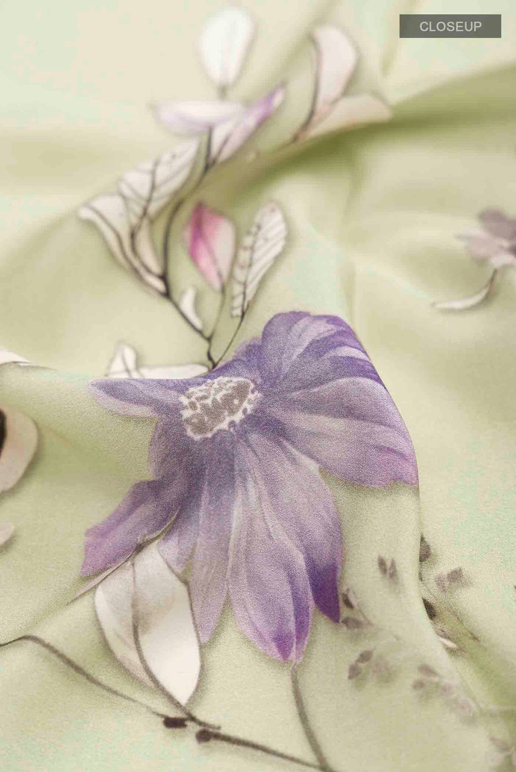 Close up of Green Mysore Crepe Saree with Printed design on the body and Plain Border displaying folds