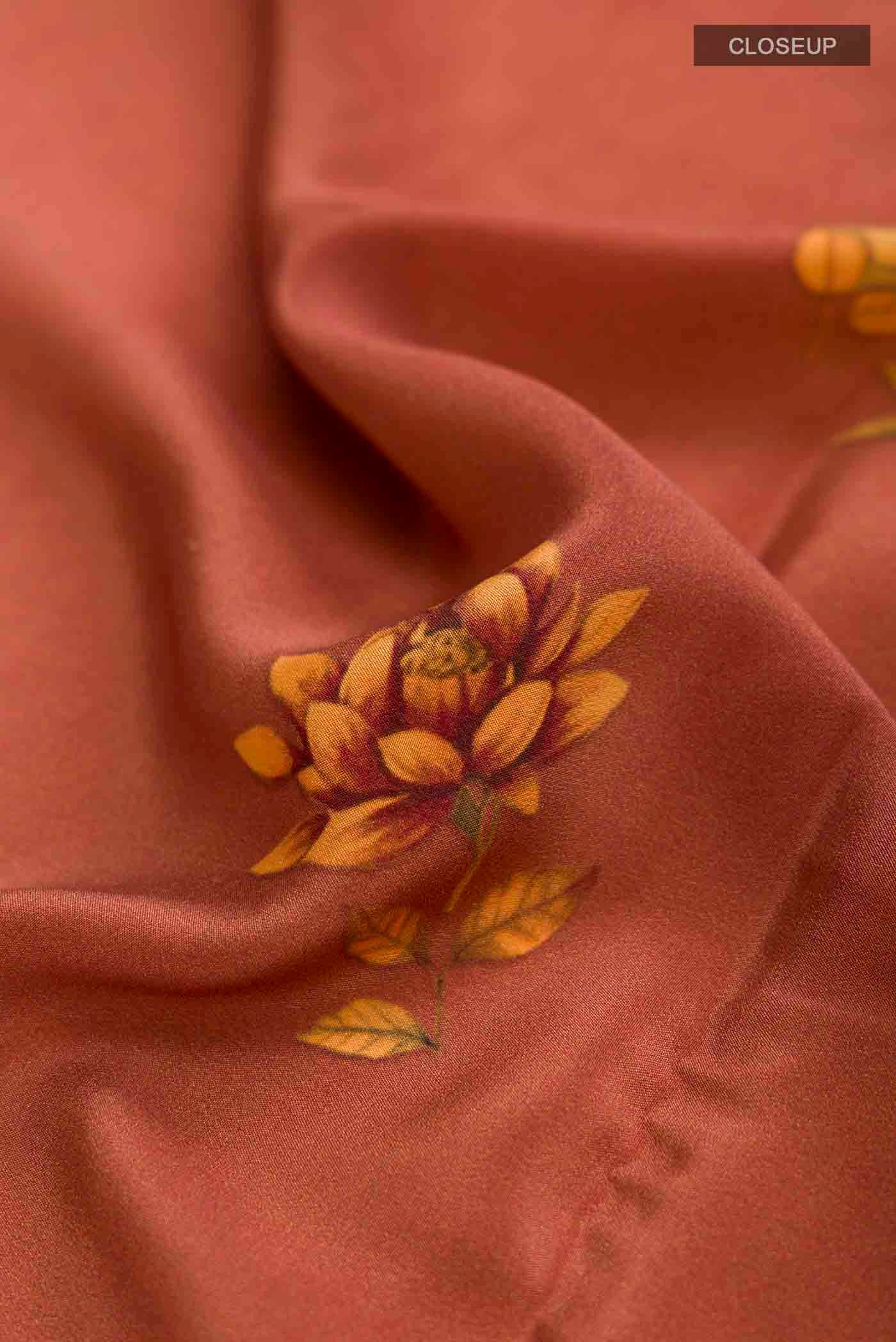 Close up of Brown Mysore Crepe Saree with Printed design on the body and Plain Border displaying folds