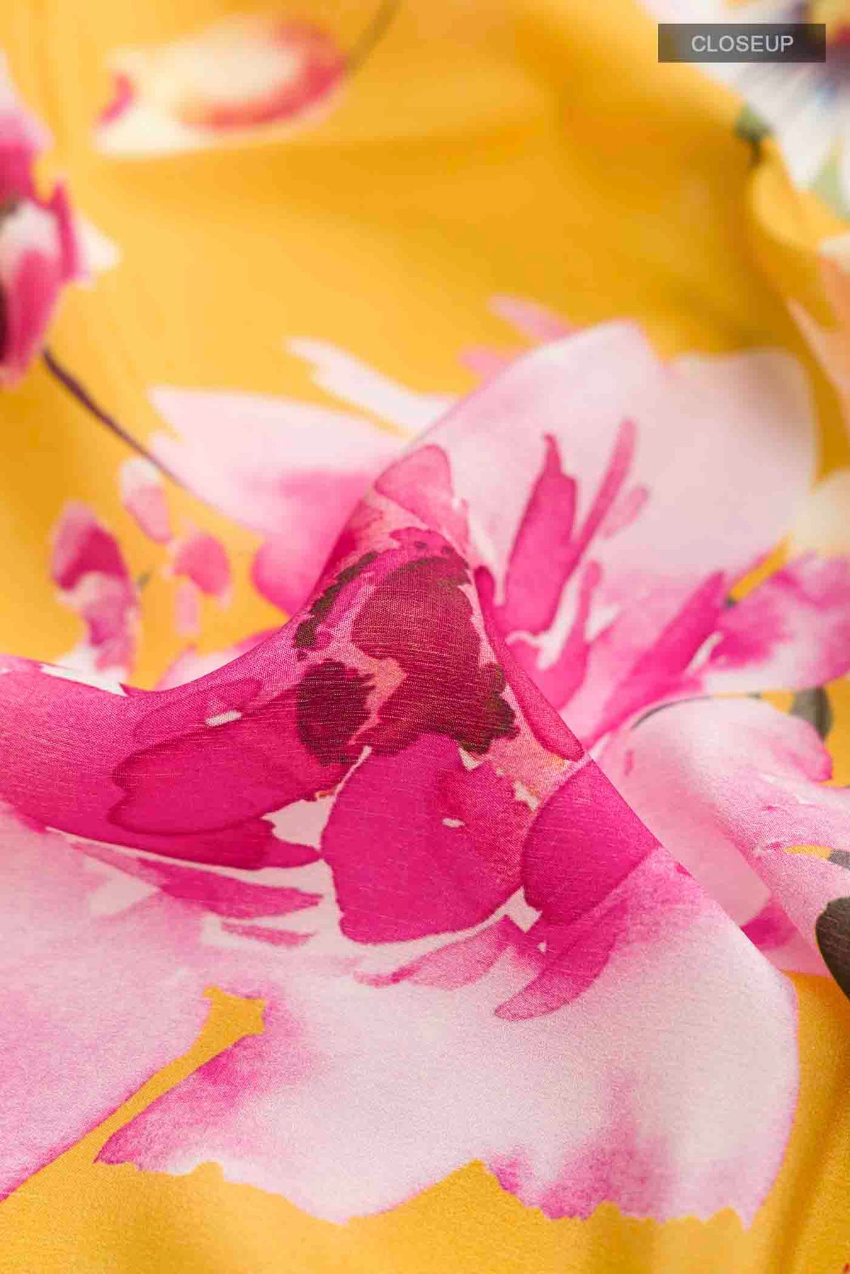 Close up of Yellow Mysore Crepe Saree with Printed design on the body and Plain Border displaying folds