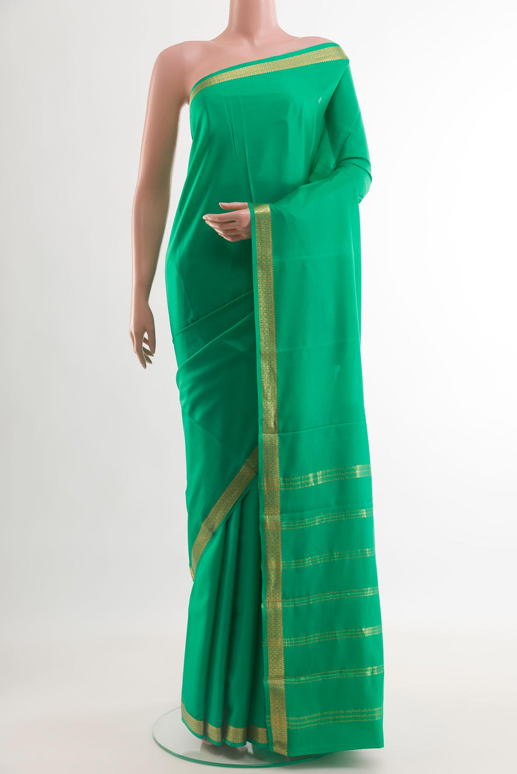 Green Mysore Crepe Saree with Plain Body and Zari Border.  displayed on a mannequin