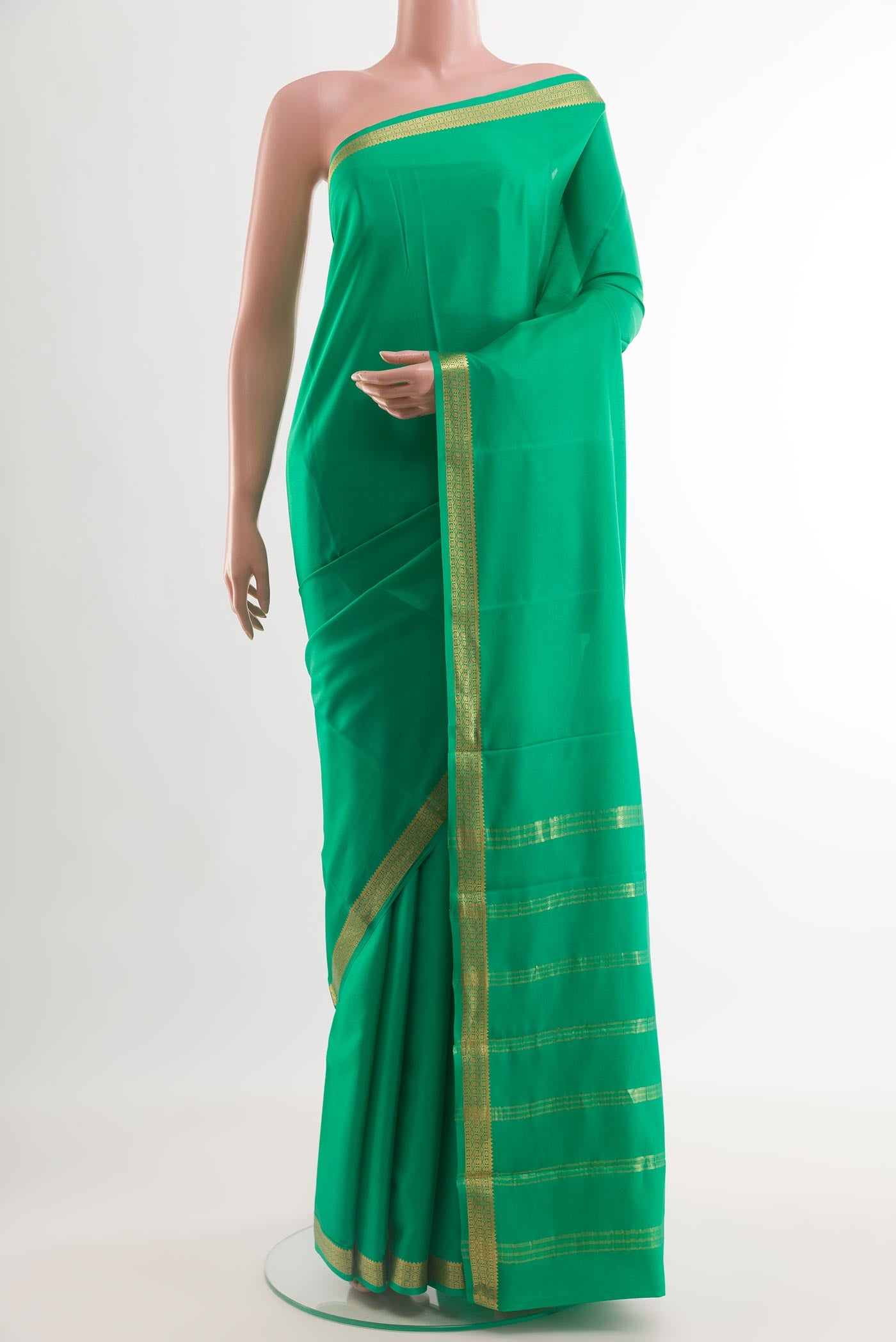 Green Mysore Crepe Saree with Plain Body and Zari Border.  displayed on a mannequin