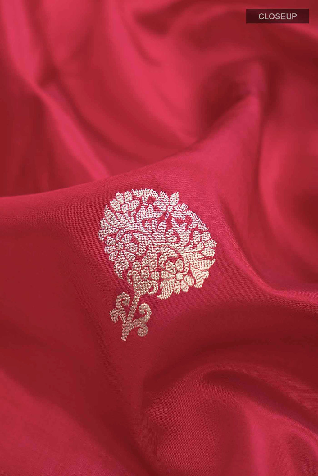 Close up of Red Banarasi Katan Silk Saree with Zari Butta on the body and Plain Border displaying folds