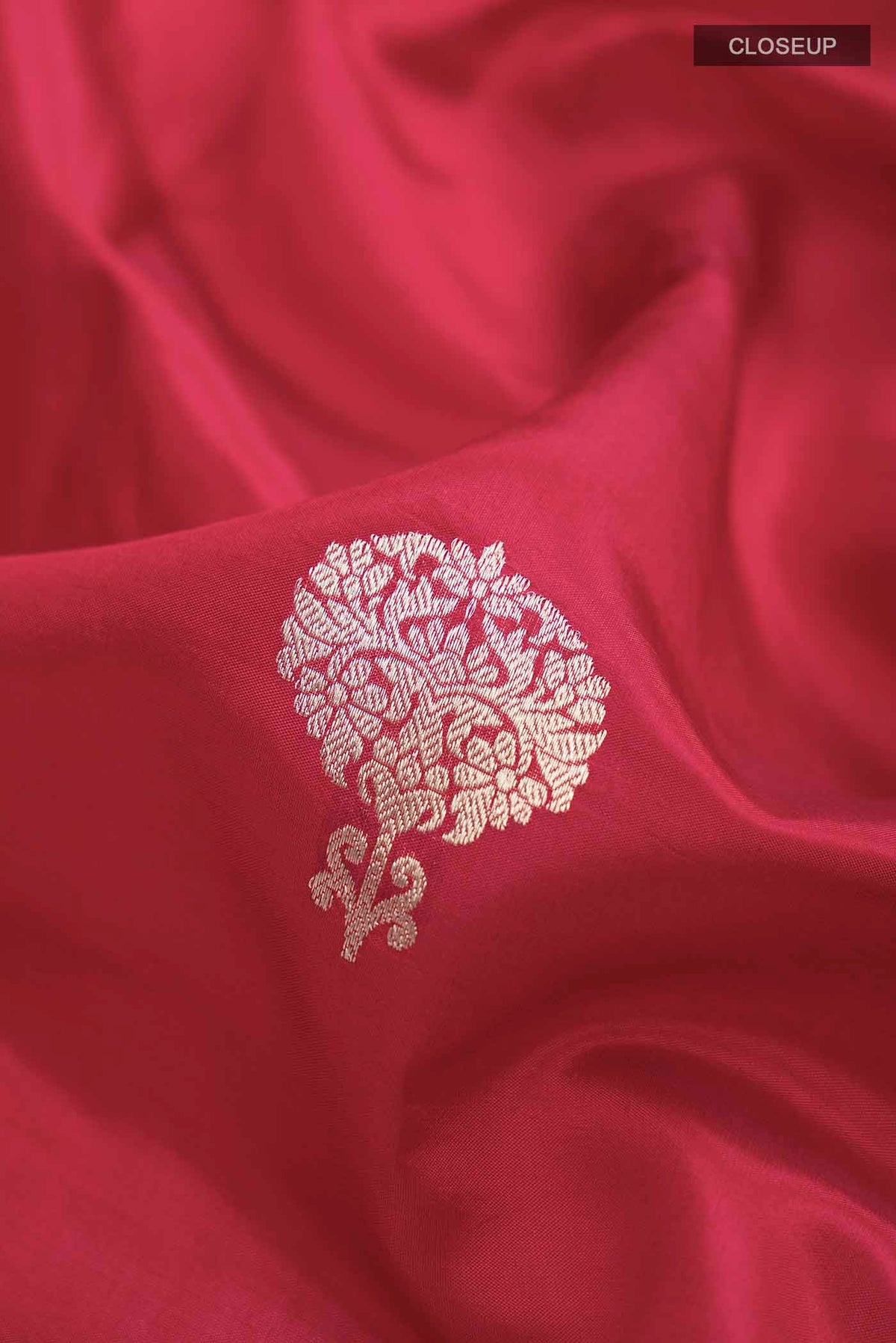 Close up of Red Banarasi Katan Silk Saree with Zari Butta on the body and Plain Border displaying folds