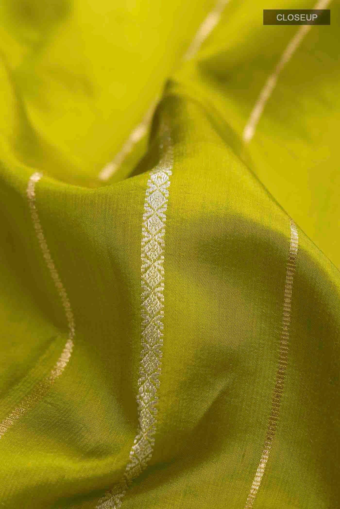 Close up of Green Banarasi Silk Saree with Stripes on the body and Zari Border displaying folds