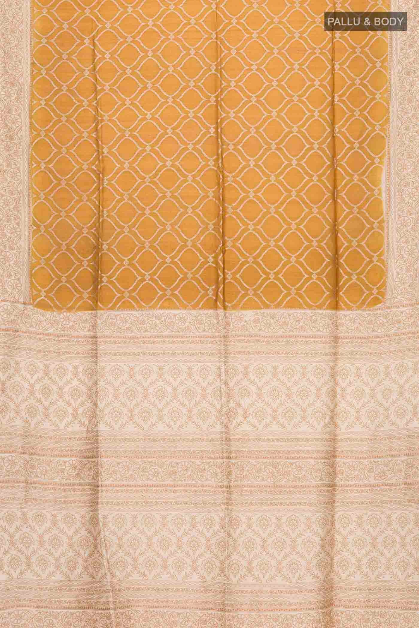 Flat view of Mustard Tussar Silk Saree with Zari Butta on the body and Embroidery Border