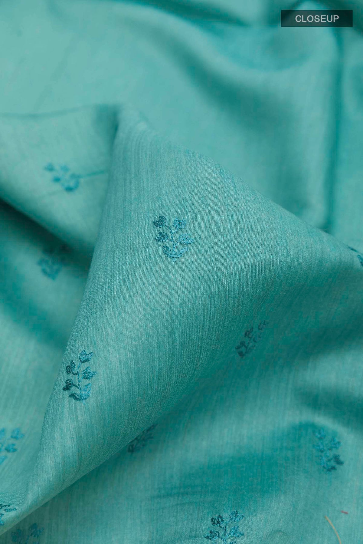Close up of Blue Tussar Saree with Thread Butta on the body and Thread Border displaying folds