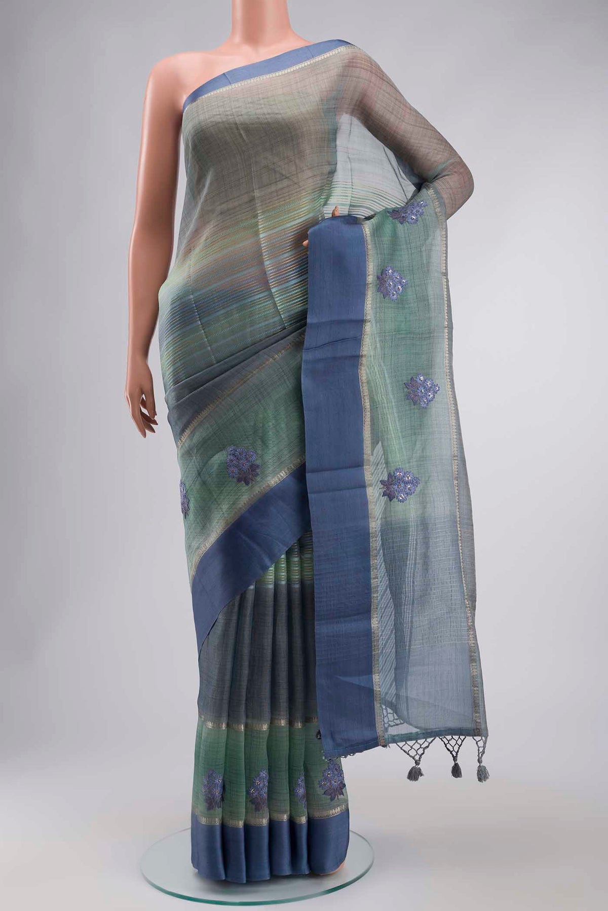 Blue Tussar Silk Saree with Stripes on the body and Zari Border displayed on a mannequin