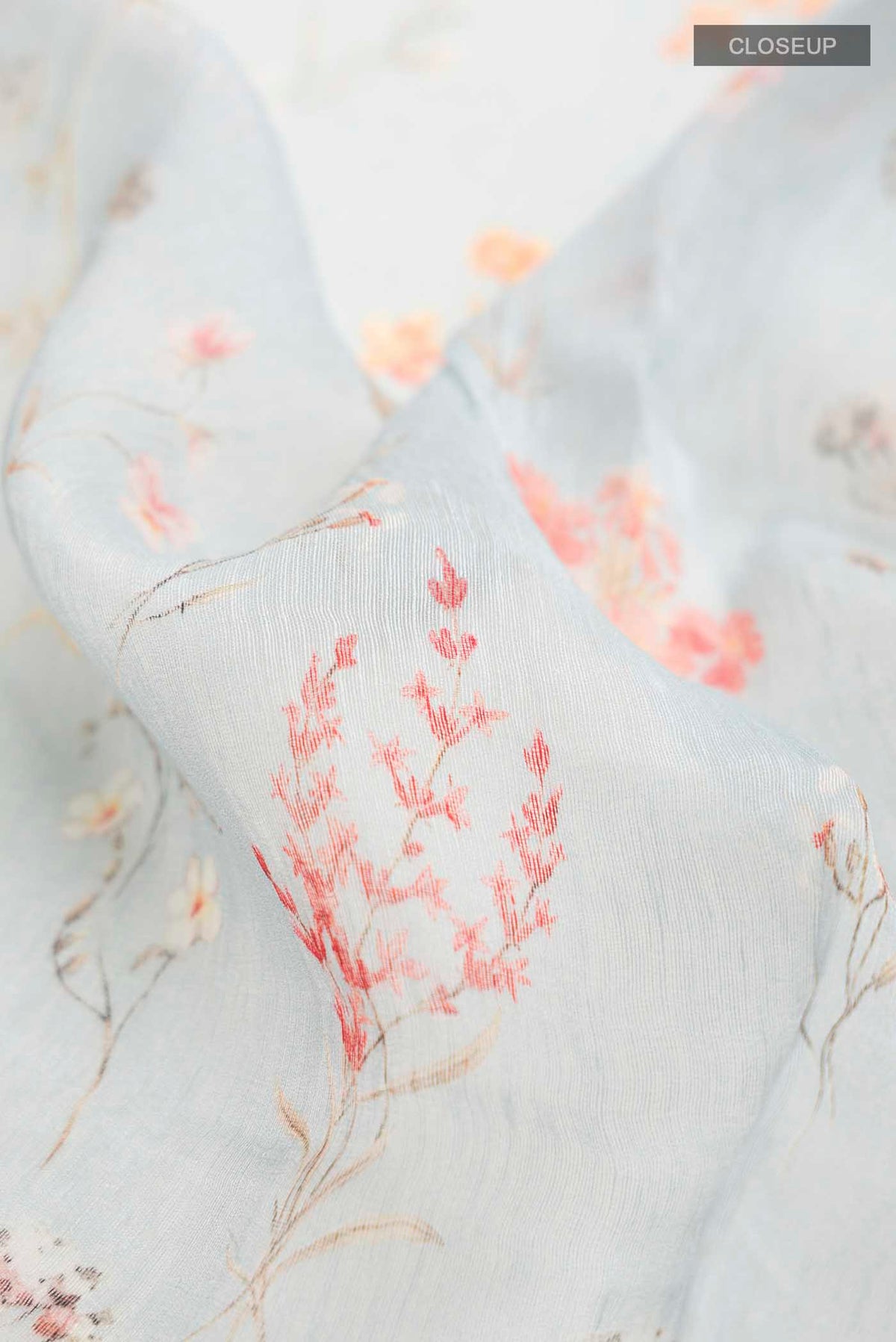 Close up of Light Blue Linen Cotton Saree with Printed design on the body and Zari Border displaying folds