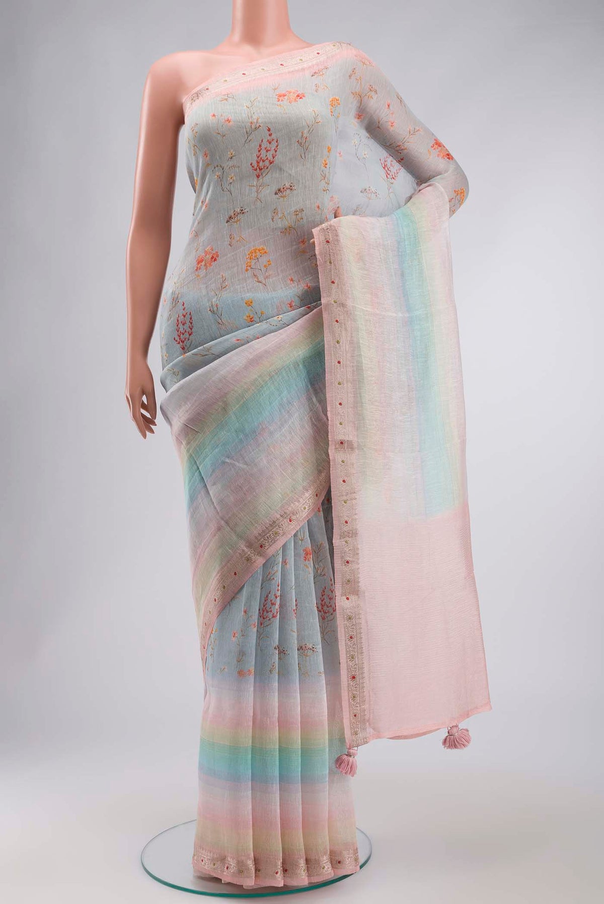 Light Blue Linen Cotton Saree with Printed design on the body and Zari Border displayed on a mannequin