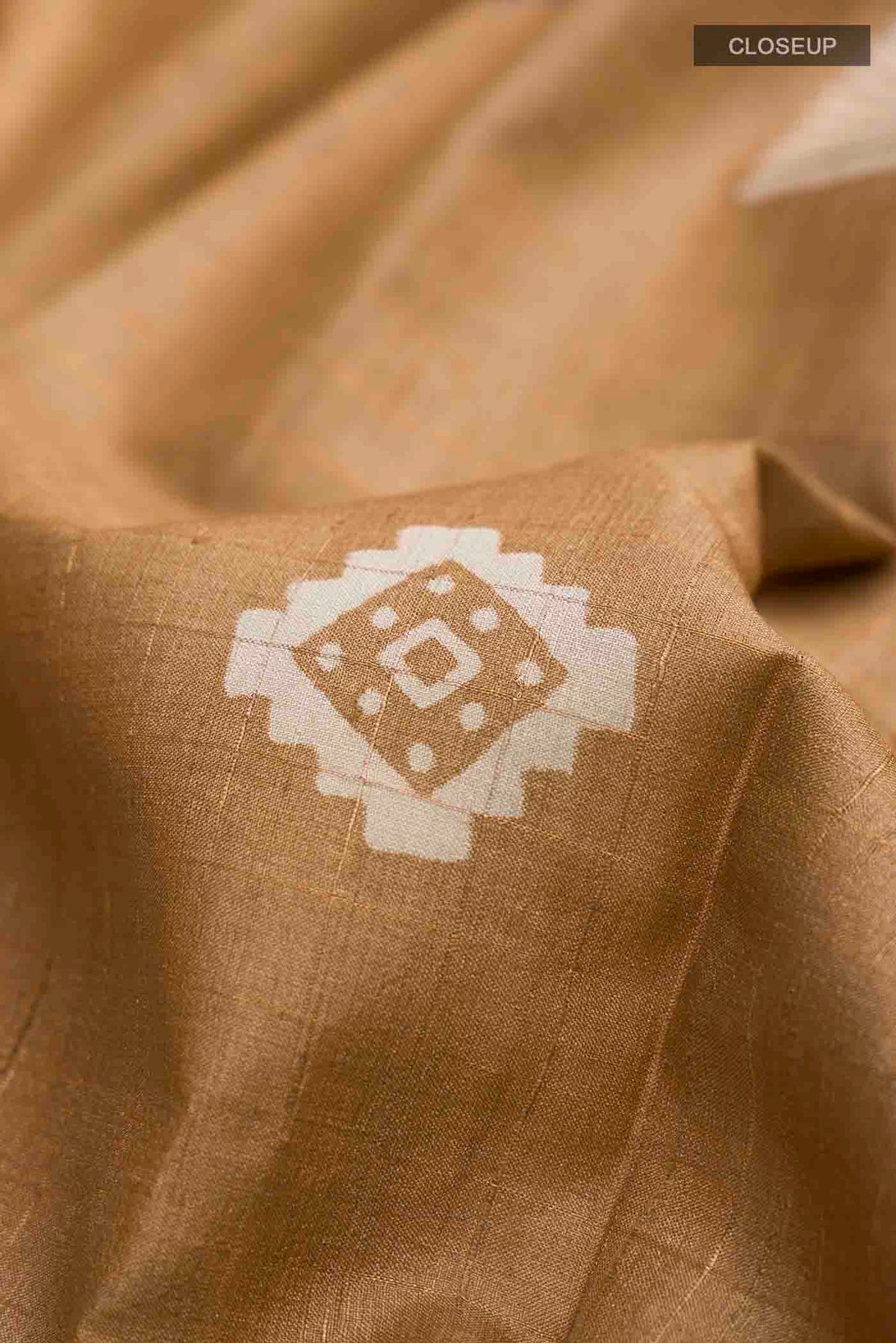 Close up of Brown Tussar Silk Saree with Checked design on the body and Plain Border displaying folds