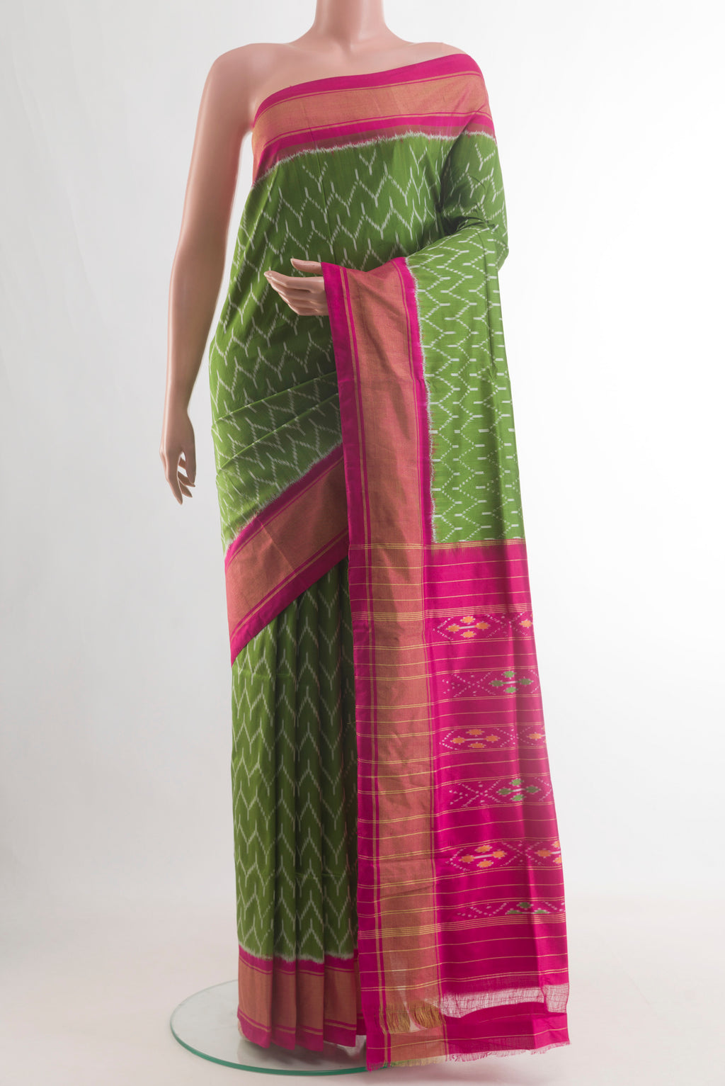 Green Pochampally Silk Saree with Pure Ikat on the body and Zari Border.  displayed on a mannequin