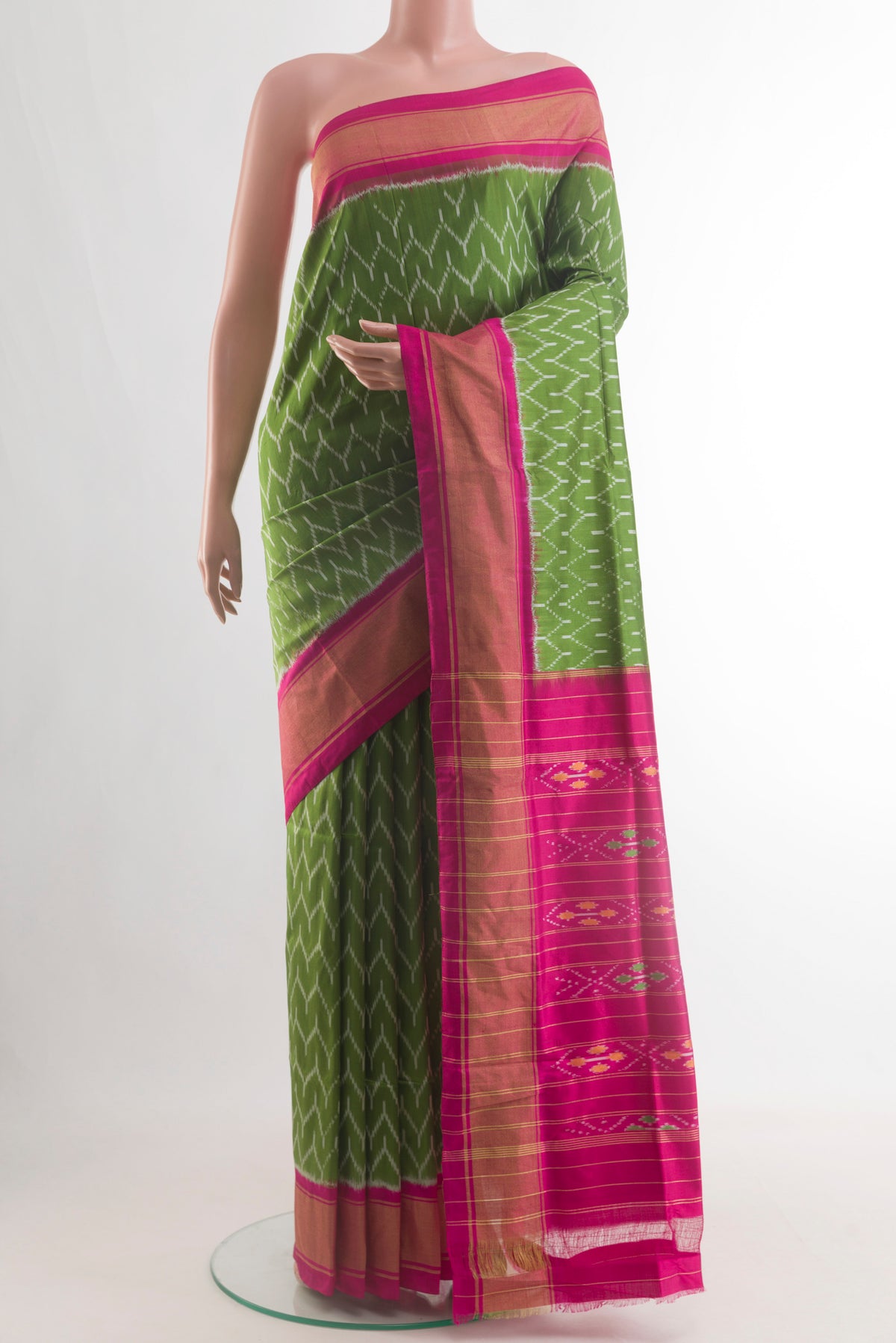 Green Pochampally Silk Saree with Pure Ikat on the body and Zari Border.  displayed on a mannequin