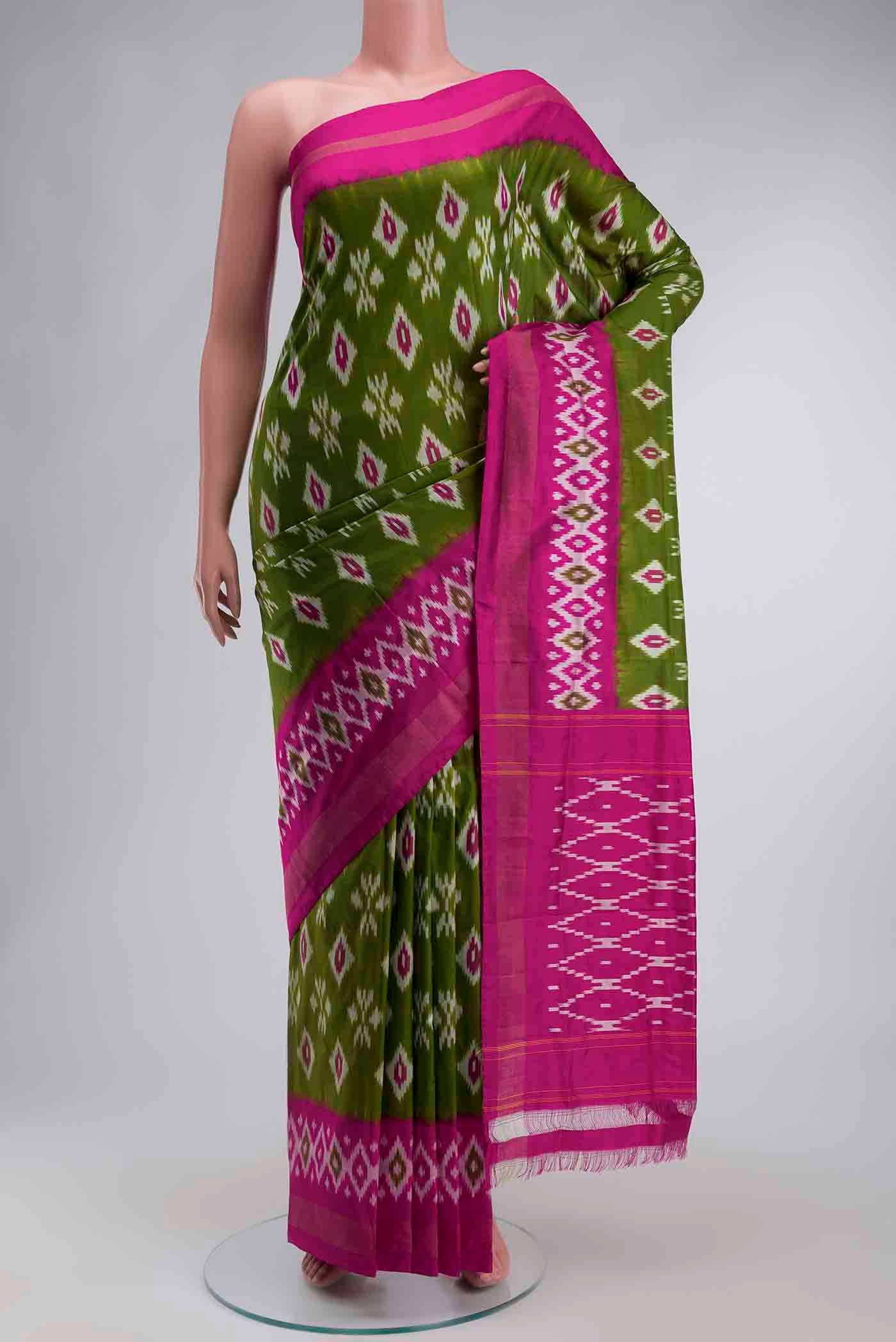 Green Pochampally Silk Saree with Ikat design on the body and Zari Border displayed on a mannequin