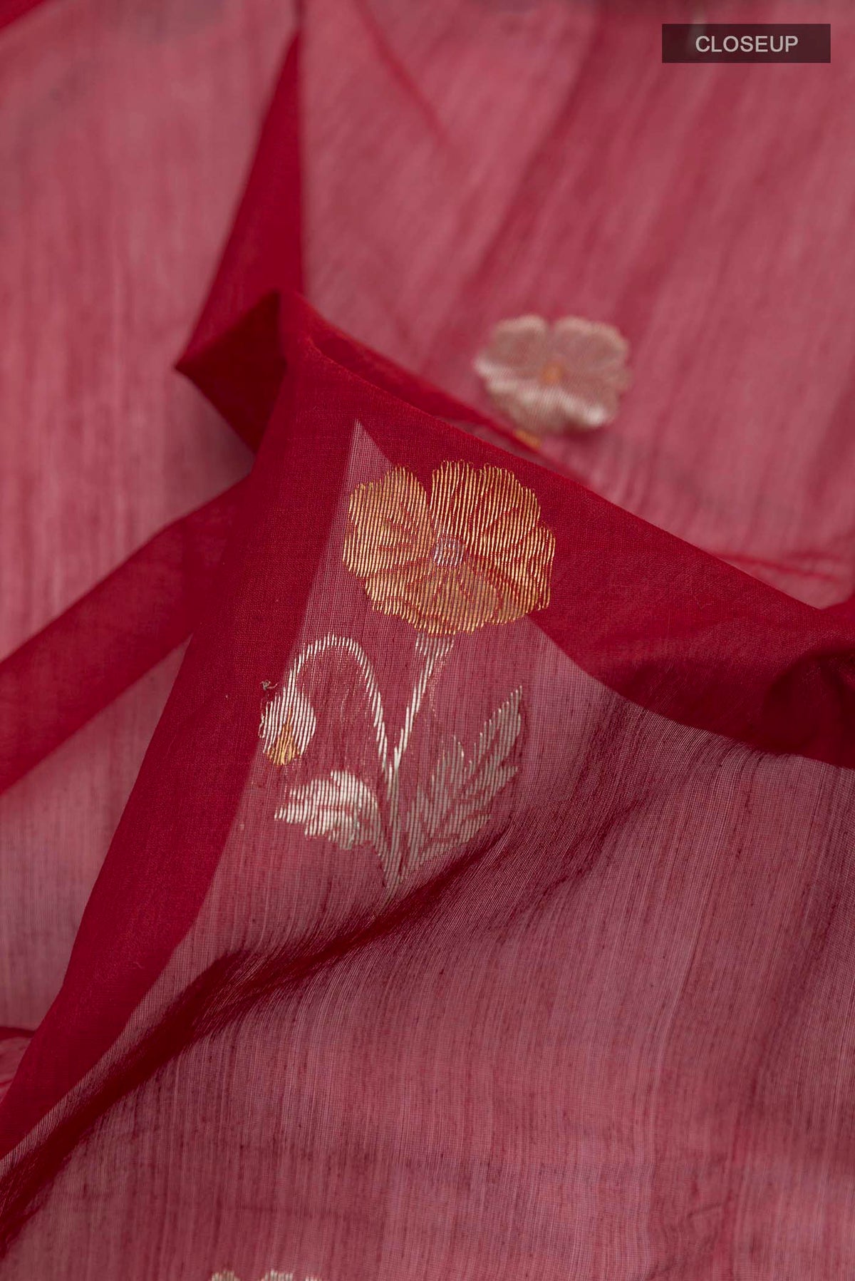 Close up of Maroon Chanderi Silk Cotton Saree with Zari Butta on the body and Zari Border displaying folds