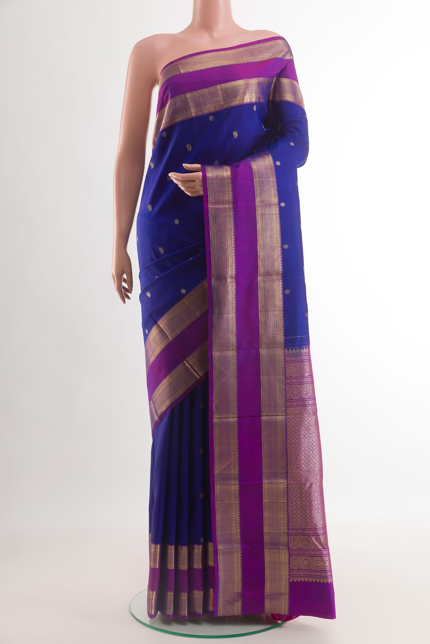 Blue Kanchipuram Silk Saree with Zari Butta on the body and Zari Border.  displayed on a mannequin