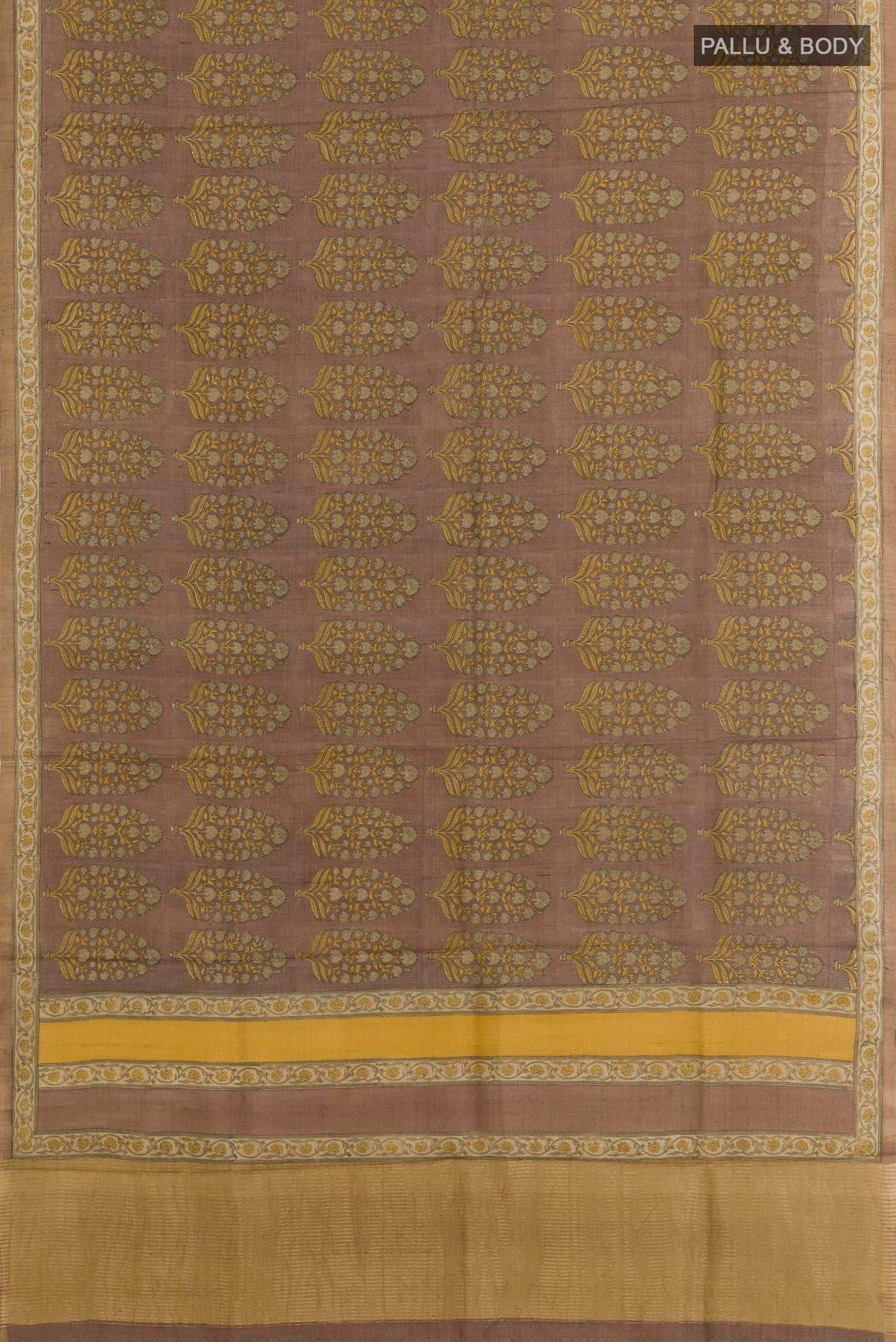 Flat view of Beige Tussar Saree with Printed design on the body and Zari Border. 