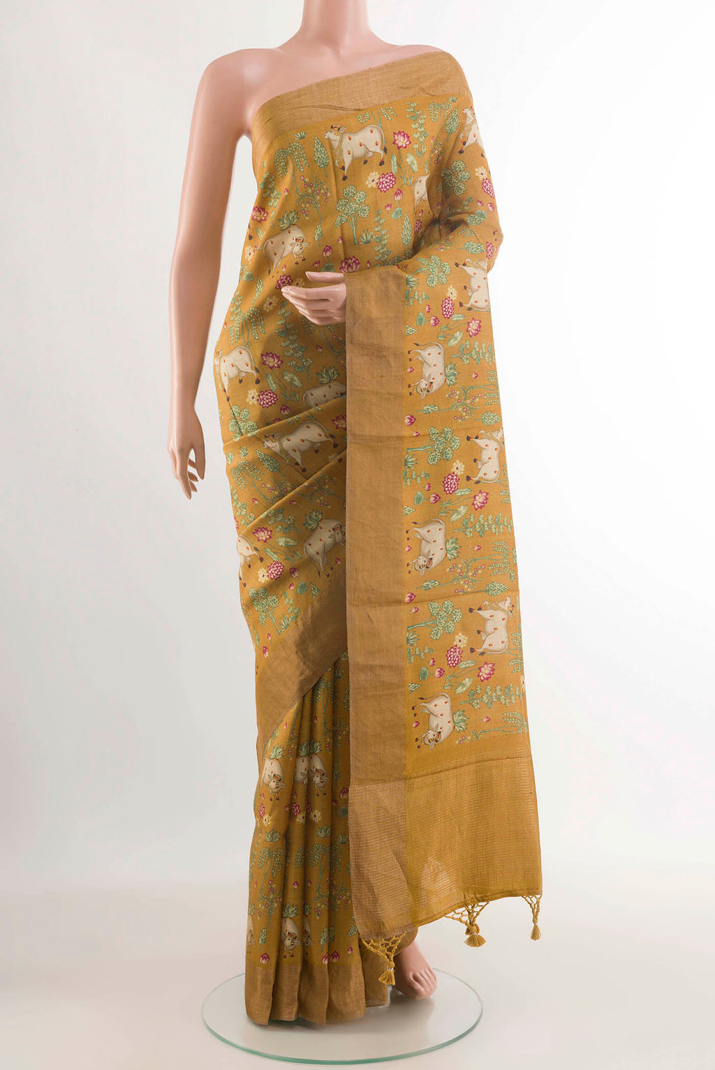 Mustard Tussar Saree with Printed design on the body and Zari Border displayed on a mannequin