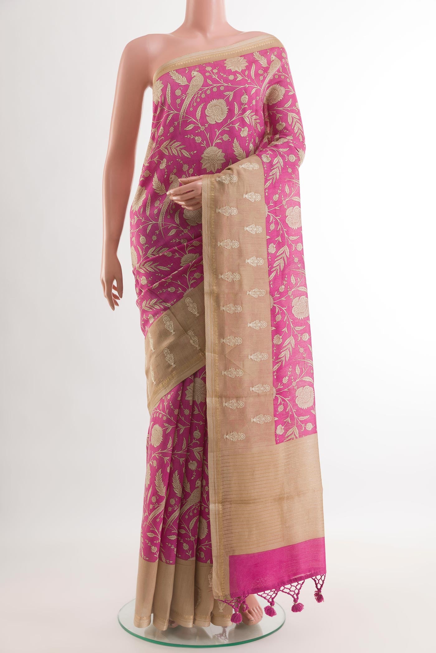 Rani Pink Tussar Silk Saree with Printed design on the body and Zari Border.  displayed on a mannequin