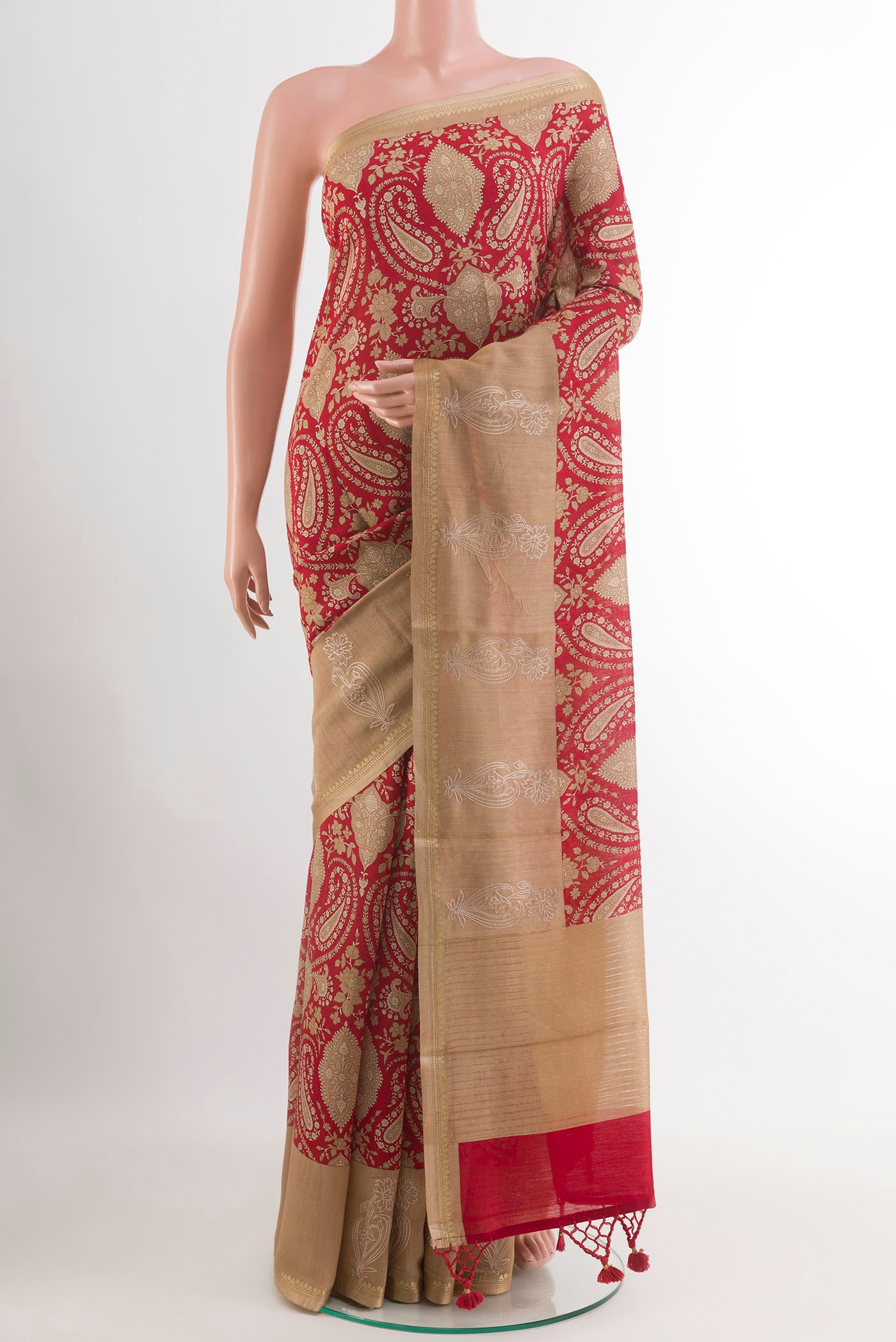 Red Tussar Saree with Printed design on the body and Printed Border.  displayed on a mannequin