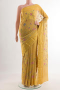 Yellow Mysore Georgette Saree with Embroidery on the body and Zari Border.  displayed on a mannequin