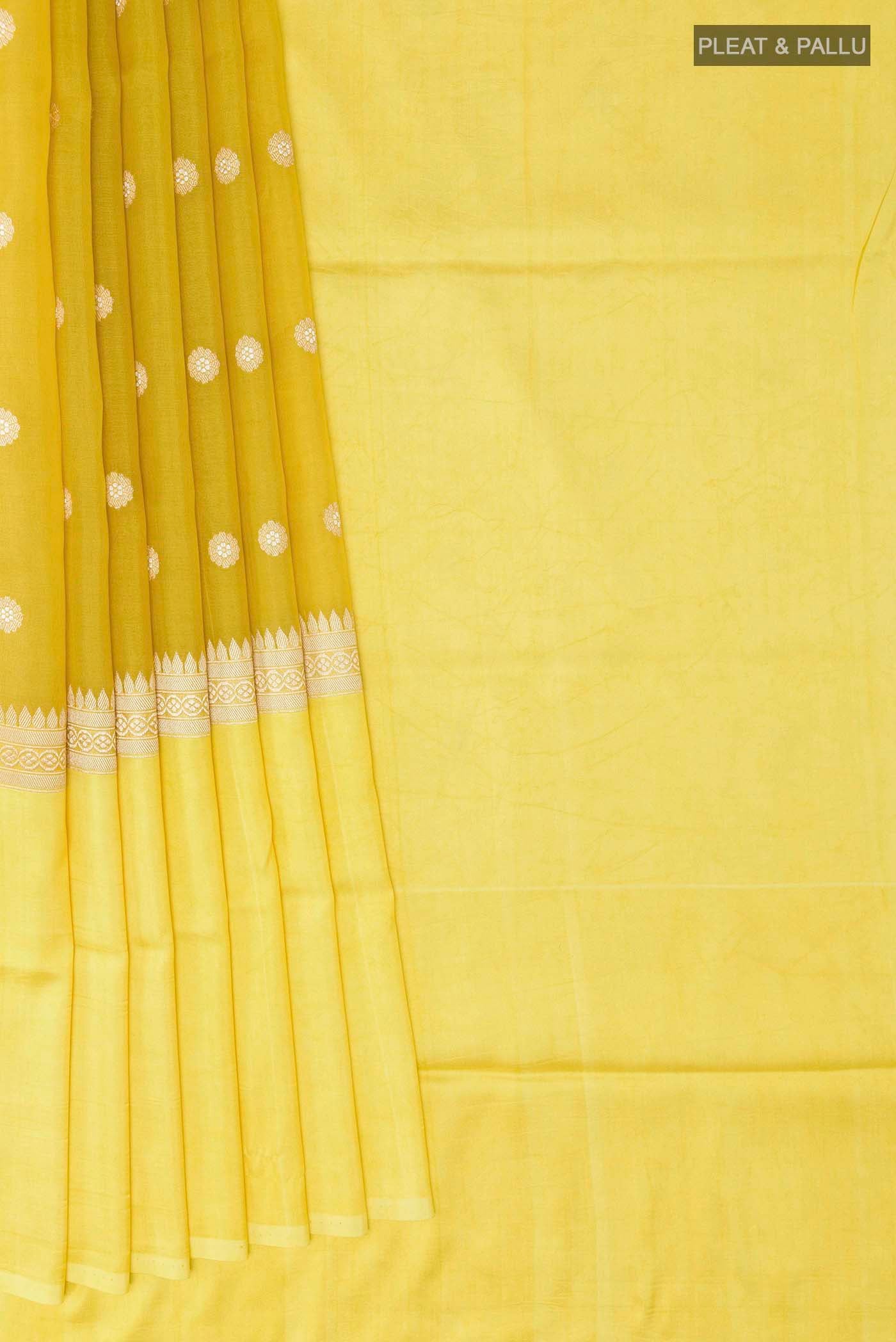 Pleats and pallu of Yellow Banarasi Kora Silk Saree with Zari Butta on the body and Zari Border