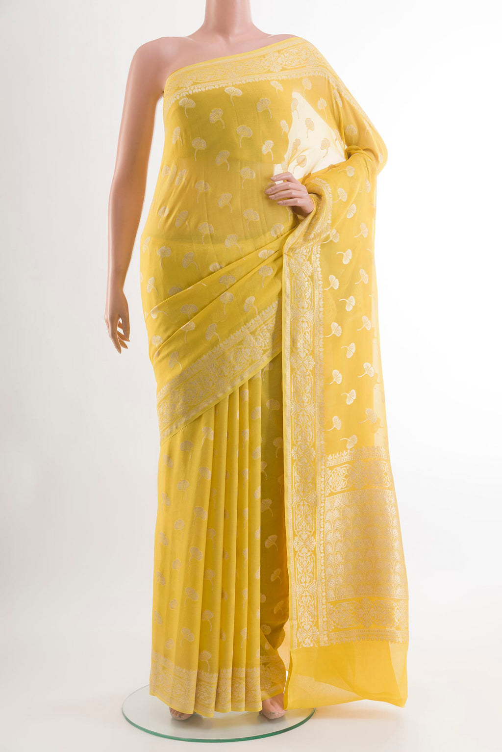 Yellow Chiffon Saree with Zari Butta on the body and Zari Border.  displayed on a mannequin