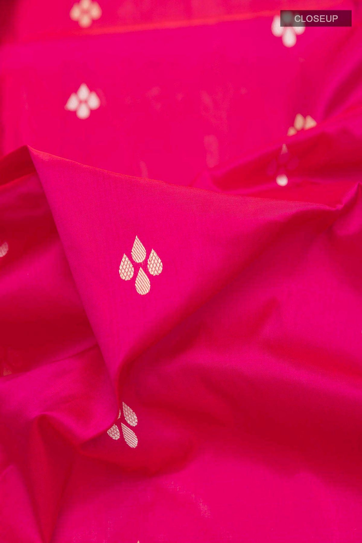 Close up of Pink Banarasi Silk Saree with Zari Butta on the body and Zari Border displaying folds