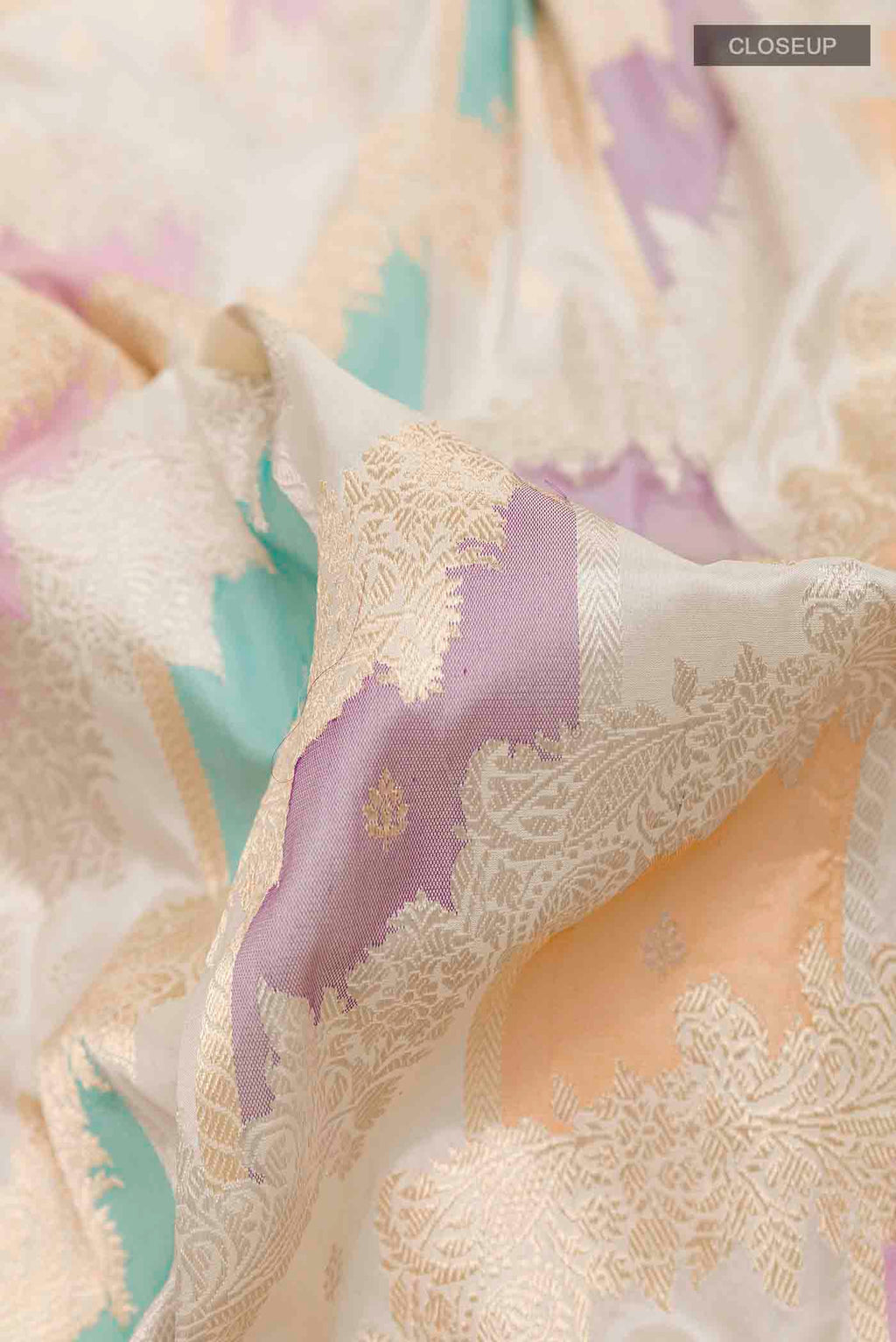 Close up of Off White Banarasi Silk Saree with Zari Brocade on the body and Zari Border displaying folds