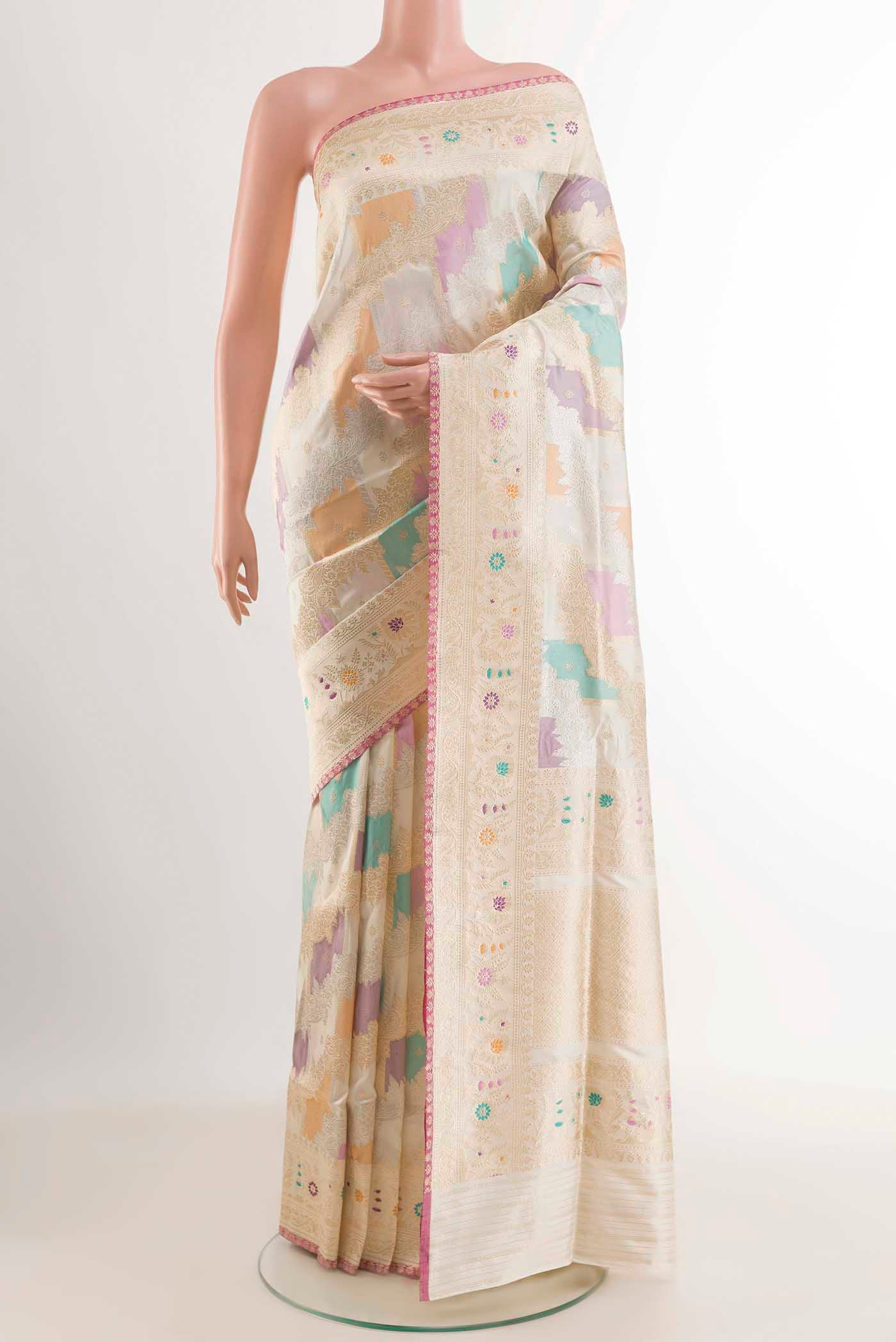 Off White Banarasi Silk Saree with Zari Brocade on the body and Zari Border displayed on a mannequin