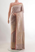 Beige Banarasi Silk Saree with Zari Butta on the body and Zari Border.  displayed on a mannequin