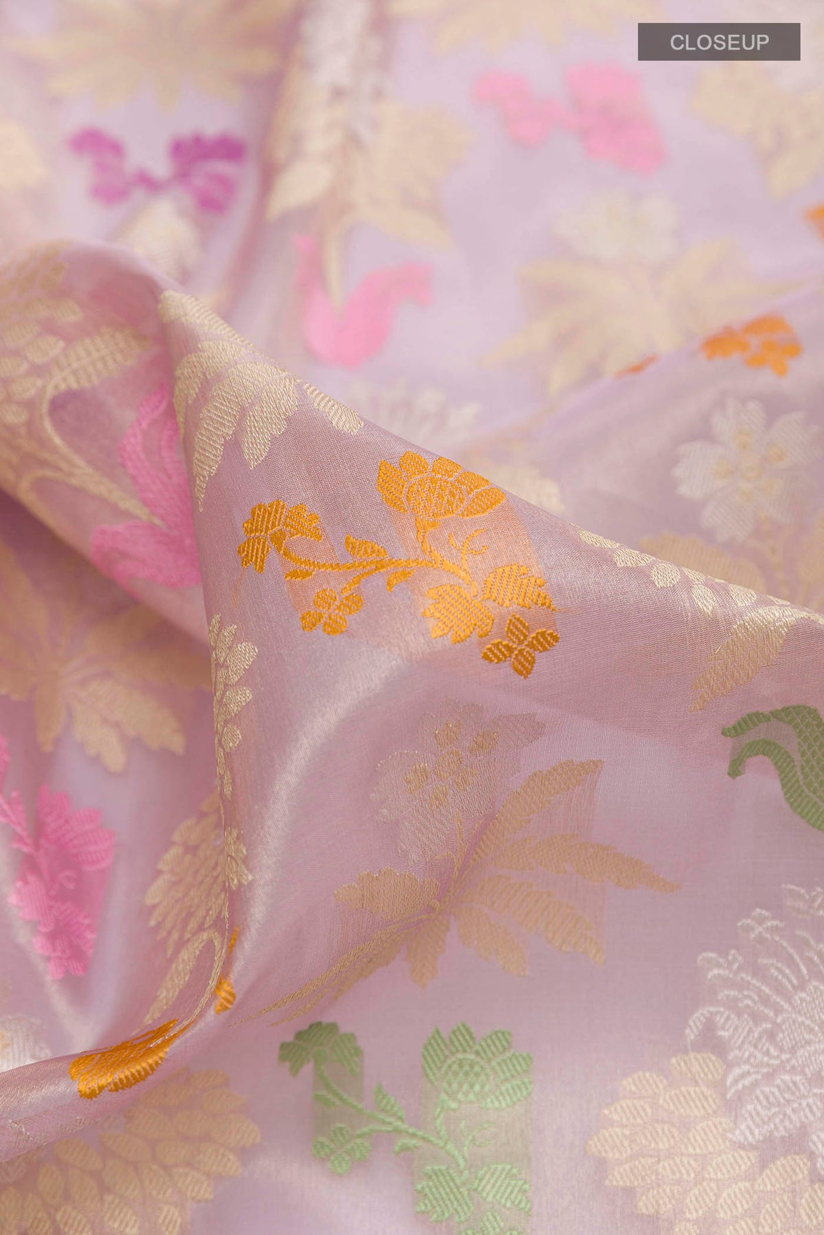Close up of Lavender Banarasi Kora Silk Saree with Zari Brocade on the body and Zari Border displaying folds