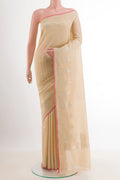 Beige Banarasi Katan Silk Saree with Zari Butta on the body and Zari Border.  displayed on a mannequin