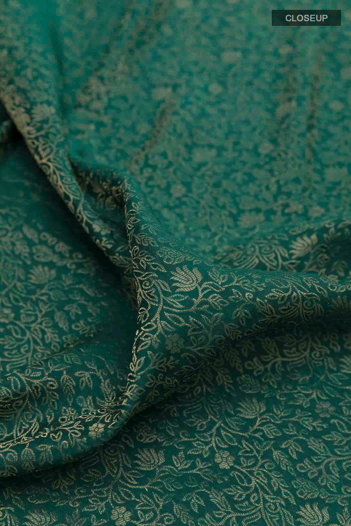 Close up of Green Mysore Crepe Saree with Zari Brocade on the body and Zari Border displaying folds
