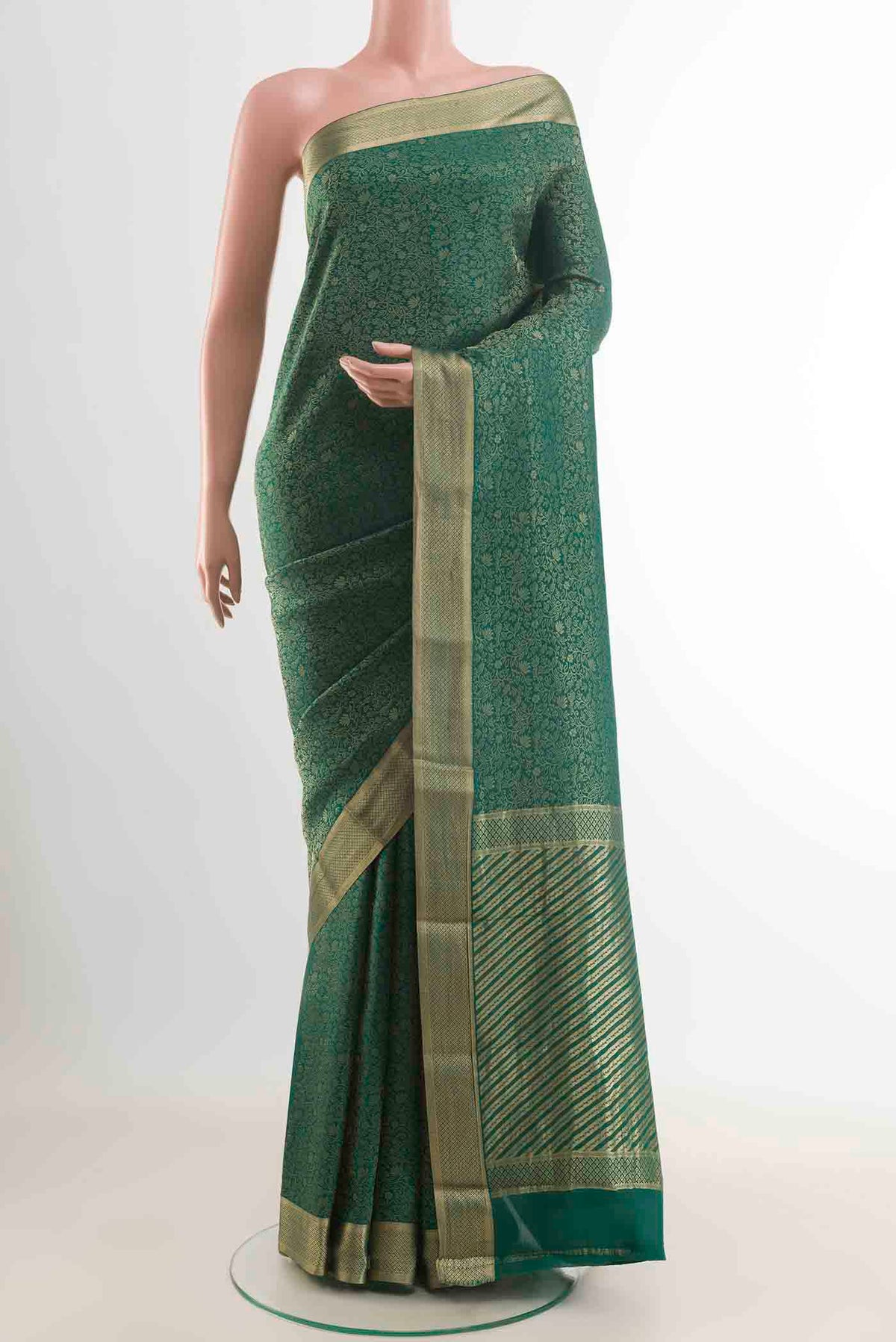Green Mysore Crepe Saree with Zari Brocade on the body and Zari Border displayed on a mannequin