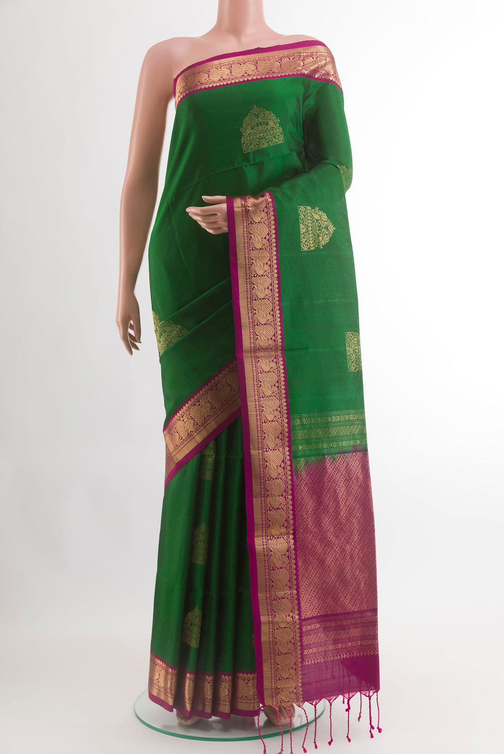 Green Soft Silk Saree with Zari Butta on the body and Zari Border.  displayed on a mannequin