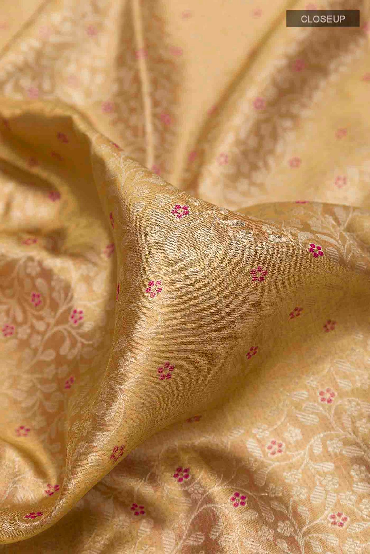 Close up of Golden Kanchipuram Tissue Silk Saree with Zari Brocade on the body and Zari Border displaying folds