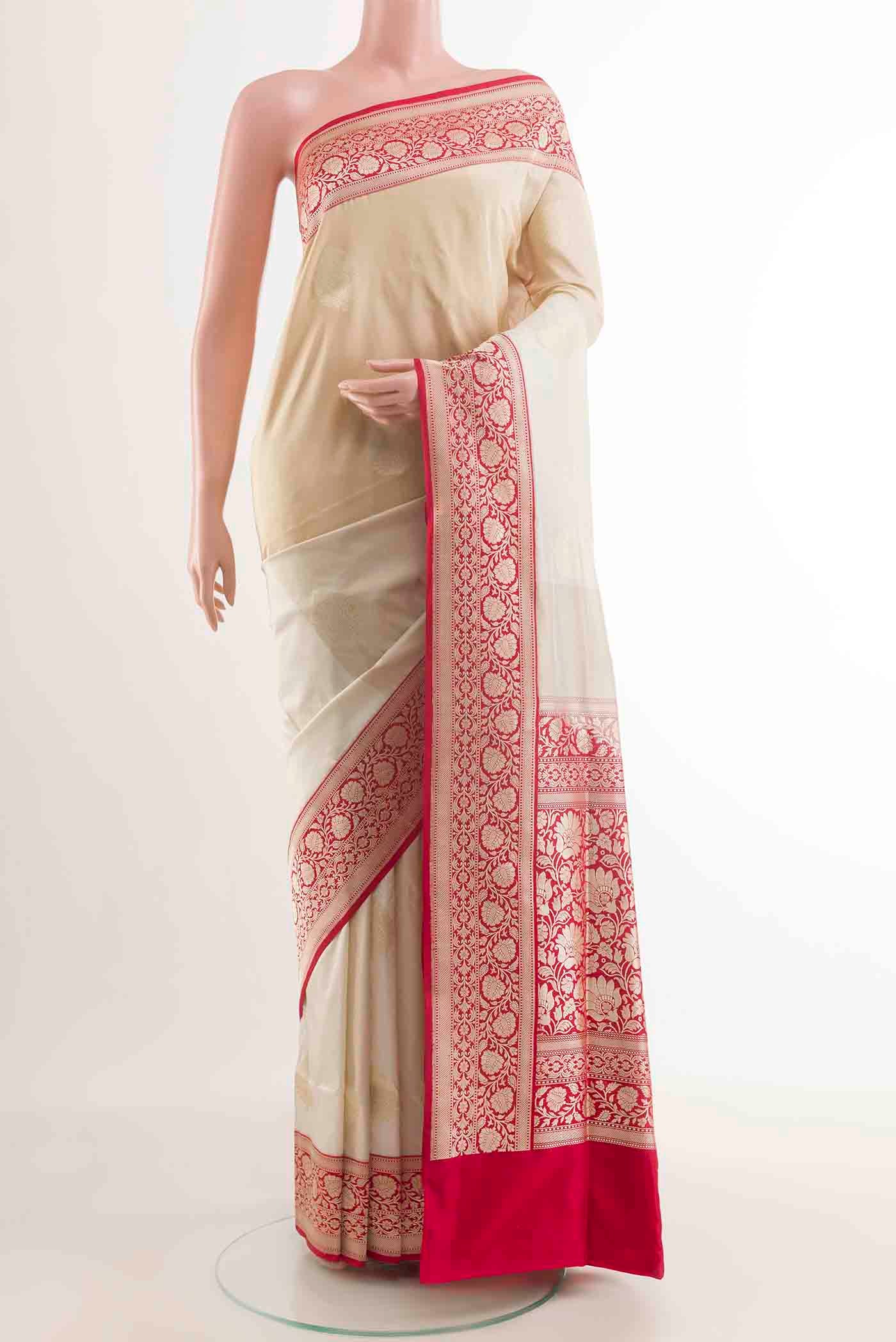 Off White Banarasi Silk Saree with Zari Butta on the body and Zari Border displayed on a mannequin